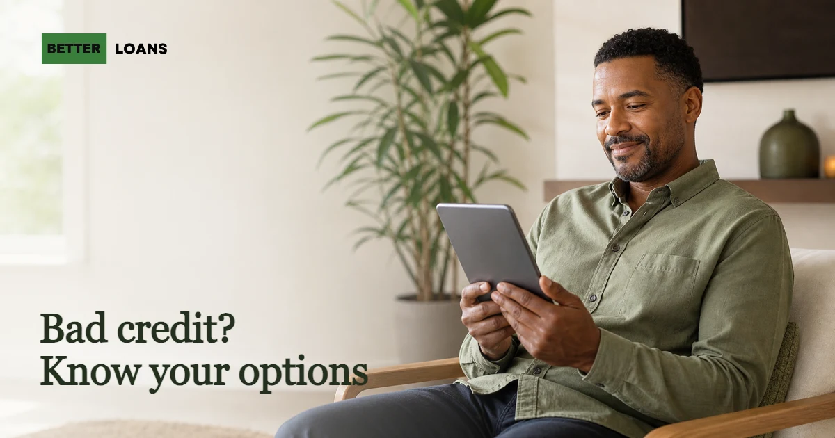 A person calmly reviewing their loan options on a tablet after being turned down for credit