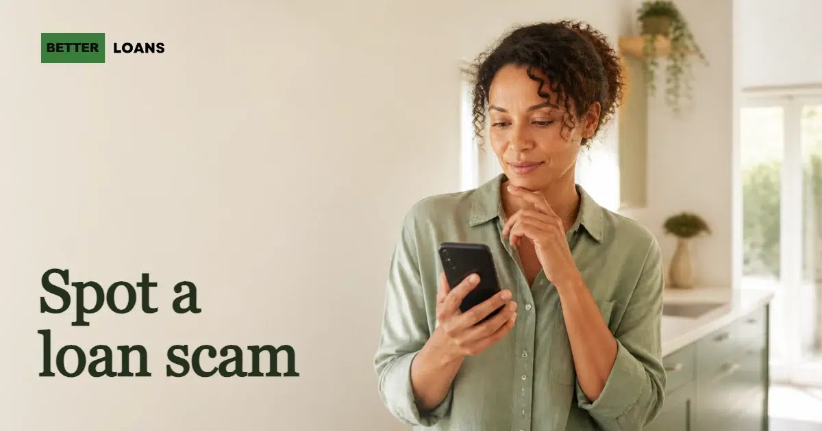 A person at a kitchen table calmly reading a loan message on a phone before deciding whether to respond
