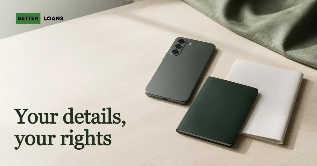Photo of a dark-green smartphone lying face-down beside a closed dark-green notebook and a folded blank document on a pale wooden table, suggesting personal information kept private